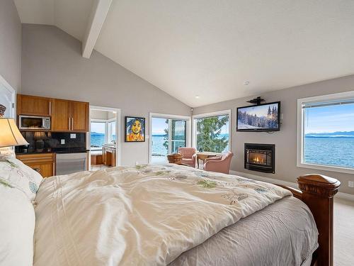 2270 Oyster Garden Rd, Campbell River, BC - Indoor Photo Showing Bedroom With Fireplace