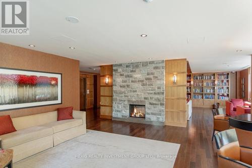 Ph10 - 1055 Southdown Road W, Mississauga, ON - Indoor Photo Showing Living Room With Fireplace