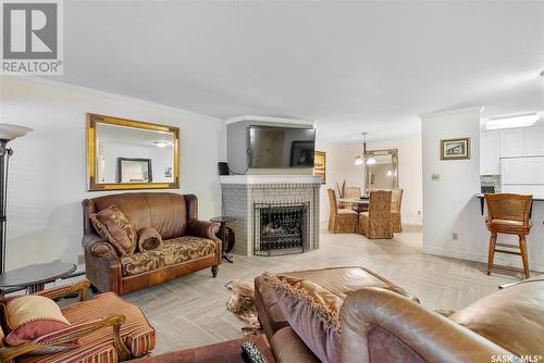 102 222 Saskatchewan Crescent E, Saskatoon, SK - Indoor Photo Showing Living Room With Fireplace
