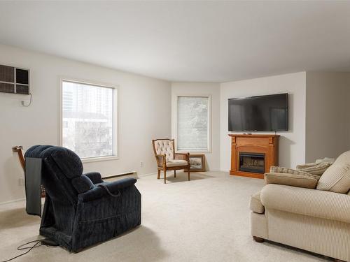 307-1385 Bertram Street, Kelowna, BC - Indoor Photo Showing Living Room With Fireplace