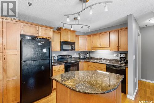 B207 103 Wellman Crescent, Saskatoon, SK - Indoor Photo Showing Kitchen With Double Sink