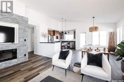 10 Plains Green, Pilot Butte, SK - Indoor Photo Showing Living Room With Fireplace