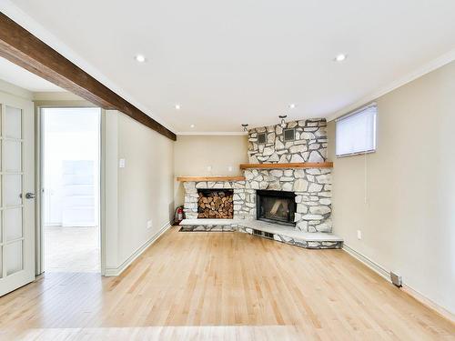 Salle familiale - 500 Rue Carignan, Boisbriand, QC - Indoor Photo Showing Living Room With Fireplace