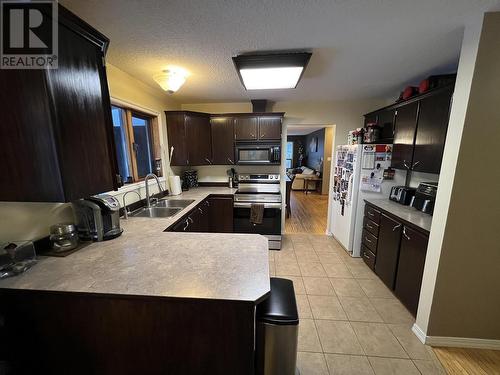 15 Walsh Road, Fort Nelson, BC - Indoor Photo Showing Kitchen With Double Sink