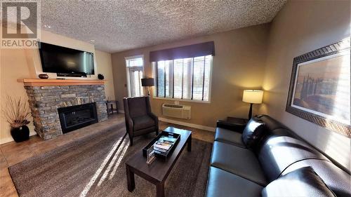 400 Bighorn  Boulevard Unit# 415 G, Radium Hot Springs, BC - Indoor Photo Showing Living Room With Fireplace