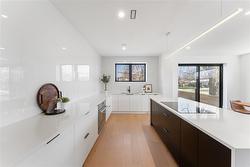 Kitchen with view to sliding doors. Steps down to private fenced patio - 