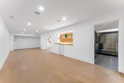 Lower level Family Room. Wet bar, bar fridge, ambient lighting on oak shelving. Spacious 3 piece bathroom. - 
