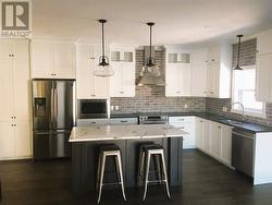 Photo is to illustrate similar kitchen layout, cabinet maker will work with Buyer to customize to buyer's taste - 