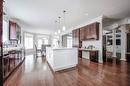Maple Hardwood Floors in large custom family kitchen - 4072 Highland Park Drive, Beamsville, ON  - Indoor 