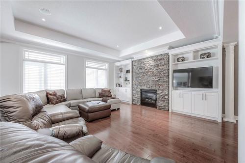 Elegant living room features nearly 10’ tray ceiling - 4072 Highland Park Drive, Beamsville, ON - Indoor Photo Showing Living Room With Fireplace