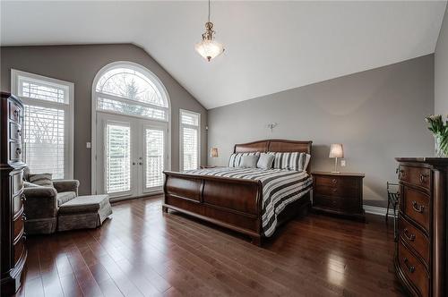 Opulent primary with Cathedral ceiling, 10’ window and Juliette balcony - 4072 Highland Park Drive, Beamsville, ON - Indoor Photo Showing Bedroom