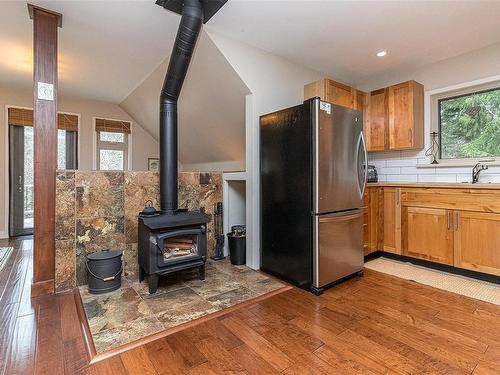 1955 Ashling Rd, Qualicum Beach, BC - Indoor Photo Showing Kitchen With Fireplace