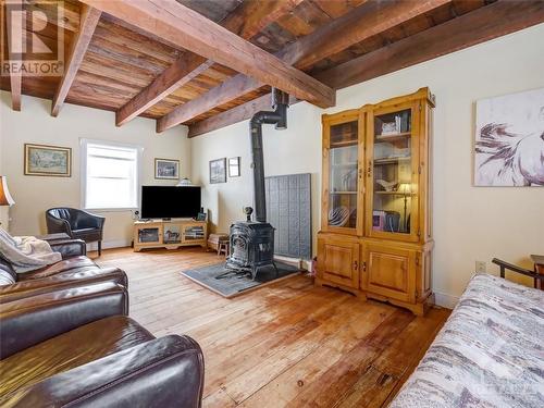 Family room with wood stove & open beam ceilings - 841 Old Union Hall Road, Almonte, ON - Indoor Photo Showing Other Room