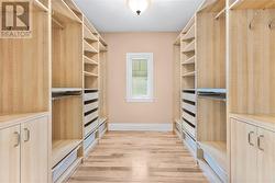 Primary walk in closet with custom built ins. - 