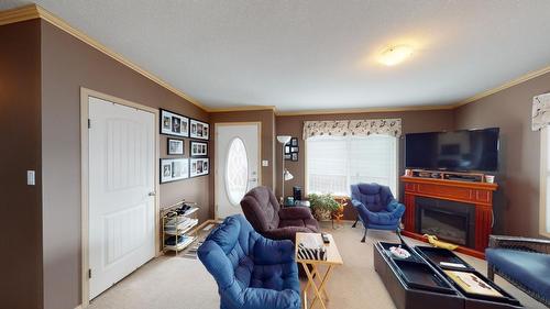 12 Pinewood Avenue Nw, Cranbrook, BC - Indoor Photo Showing Living Room With Fireplace