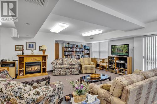 #211 -8 Huron St, Kawartha Lakes, ON - Indoor Photo Showing Living Room With Fireplace