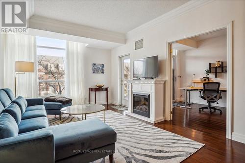 208 - 80 Port Street E, Mississauga, ON - Indoor Photo Showing Living Room With Fireplace