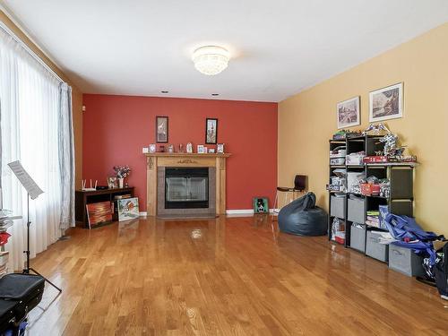 Family room - 207 Rue Sidney-Cunningham, Beaconsfield, QC - Indoor Photo Showing Other Room With Fireplace