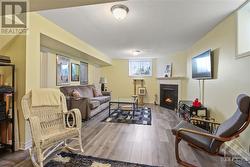 Lower level family room with extra large windows and a cozy natural gas fireplace - 