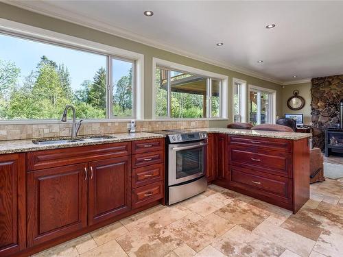 4085 Carey Pl, Royston, BC - Indoor Photo Showing Kitchen With Fireplace With Double Sink