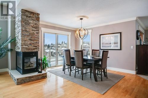 313 Tanager Drive, Kelowna, BC - Indoor Photo Showing Dining Room With Fireplace