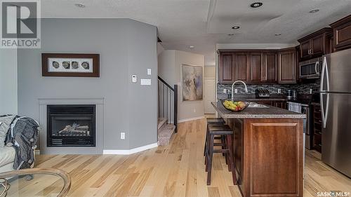 D4 33 Wood Lily Drive, Moose Jaw, SK - Indoor Photo Showing Kitchen With Fireplace