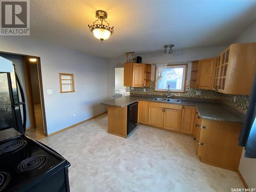 312 3Rd Avenue W, Kindersley, SK - Indoor Photo Showing Kitchen With Double Sink