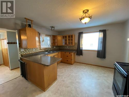 312 3Rd Avenue W, Kindersley, SK - Indoor Photo Showing Kitchen With Double Sink