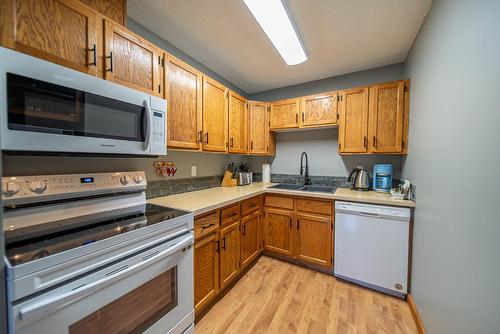 100 - 5369 Ski Hill Road, Fernie, BC - Indoor Photo Showing Kitchen With Double Sink