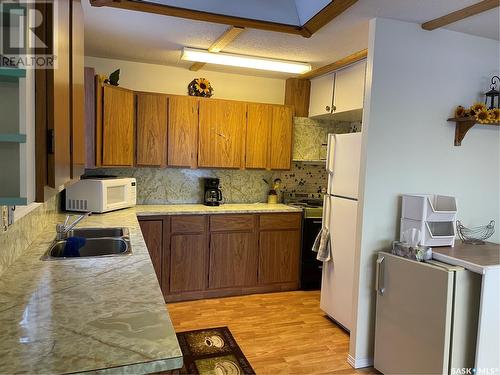27 Oskunamoo Drive, Greenwater Provincial Park, SK - Indoor Photo Showing Kitchen With Double Sink