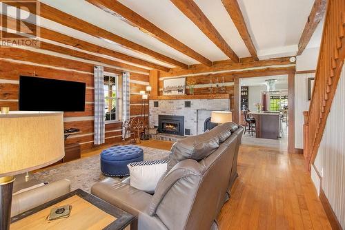 Love this log living room with exposed beams and cozy gas fireplace - 342 Mountainview Road, Arnprior, ON - Indoor Photo Showing Other Room With Fireplace