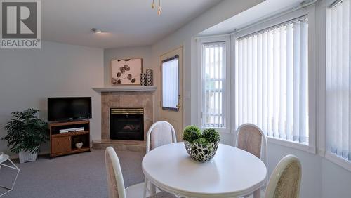 1634 Carmi Avenue Unit# 120, Penticton, BC - Indoor Photo Showing Dining Room With Fireplace