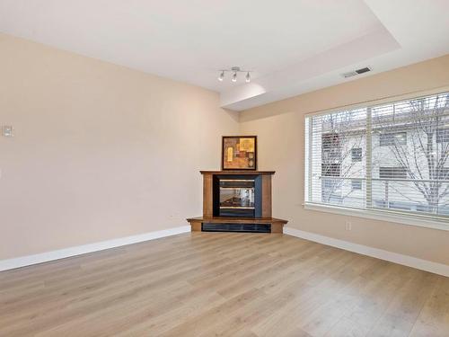 212-1007 Harvey Avenue, Kelowna, BC - Indoor Photo Showing Other Room With Fireplace