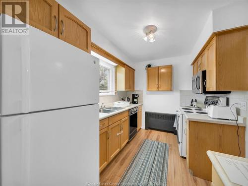 11890 Riverside Drive East Unit# A, Windsor, ON - Indoor Photo Showing Kitchen With Double Sink