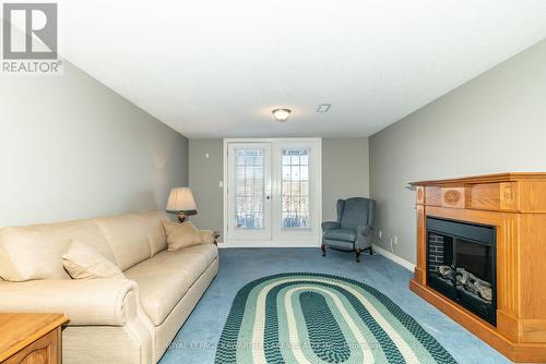 4E - 40 Rivermill Boulevard, Kawartha Lakes, ON - Indoor Photo Showing Living Room With Fireplace