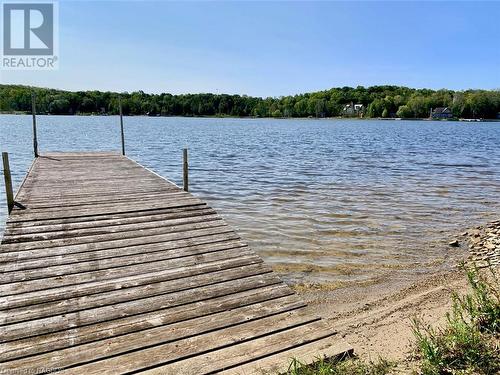 Property purchase includes a separate 21ft x 155ft waterfront lot across the road with a private dock. - 61 North Shore Road, Northern Bruce Peninsula, ON - Outdoor With Body Of Water With View