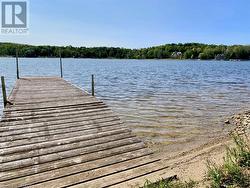 Property purchase includes a separate 21ft x 155ft waterfront lot across the road with a private dock. - 