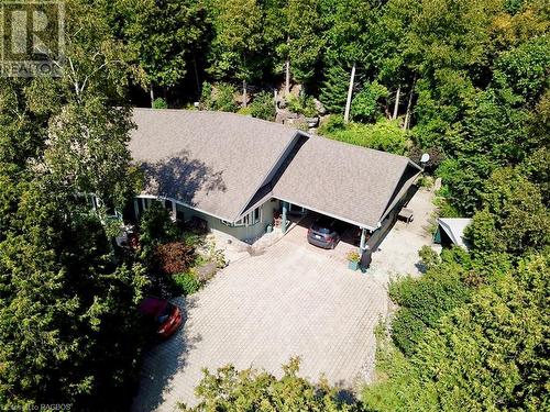 Completely hidden within the trees is this 1,824 sq ft bungalow offering one-floor living and featuring warm in-floor radiant heat throughout. - 61 North Shore Road, Northern Bruce Peninsula, ON - Outdoor