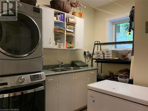 Modern fully finished laundry room with plenty of storage and double sinks. - 61 North Shore Road, Northern Bruce Peninsula, ON - Indoor Photo Showing Laundry Room