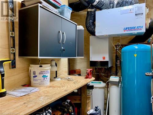 Utility / workshop houses modern mechanicals including new (2022) on-demand water heater, air exchanger, water softener treatment system, and electrical service (w/automatic back-up propane powered ge - 61 North Shore Road, Northern Bruce Peninsula, ON - Indoor