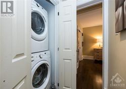 Laundry tucked in off the hall - 