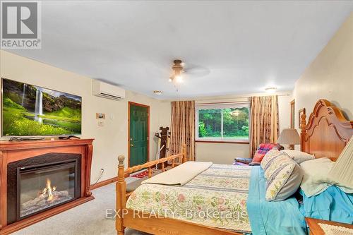 9 Riverside Cres, Wasaga Beach, ON - Indoor Photo Showing Bedroom With Fireplace