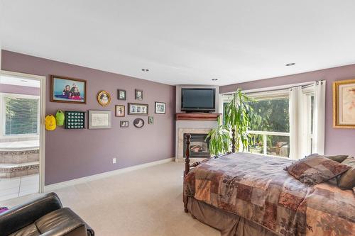 880 Waterloo Road, Castlegar, BC - Indoor Photo Showing Bedroom With Fireplace