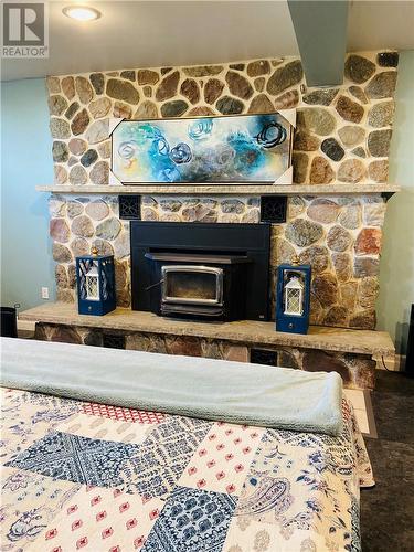 1947 Highway 540, Little Current, ON - Indoor Photo Showing Bedroom With Fireplace