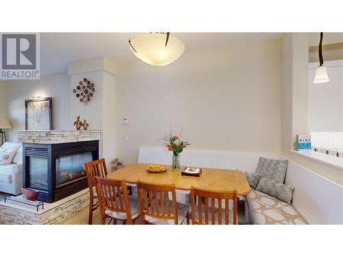 3996 Beach Avenue Unit# 205, Peachland, BC - Indoor Photo Showing Dining Room With Fireplace