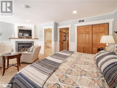 1020 Birch Glen Road Unit# Villa 7 W8, Baysville, ON - Indoor Photo Showing Bedroom With Fireplace