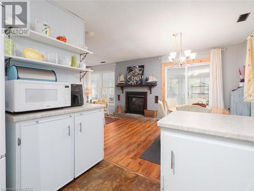 1034 Dorcas Bay Road, Tobermory, ON - Indoor Photo Showing Kitchen With Fireplace