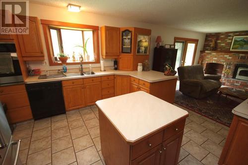 4301 Mclean Creek Road, Okanagan Falls, BC - Indoor Photo Showing Kitchen With Fireplace With Double Sink