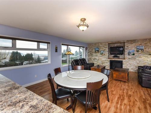 3828 Laurel Dr, Royston, BC - Indoor Photo Showing Dining Room With Fireplace