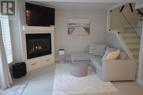 8 - 15 28Th Street N, Wasaga Beach, ON - Indoor Photo Showing Living Room With Fireplace